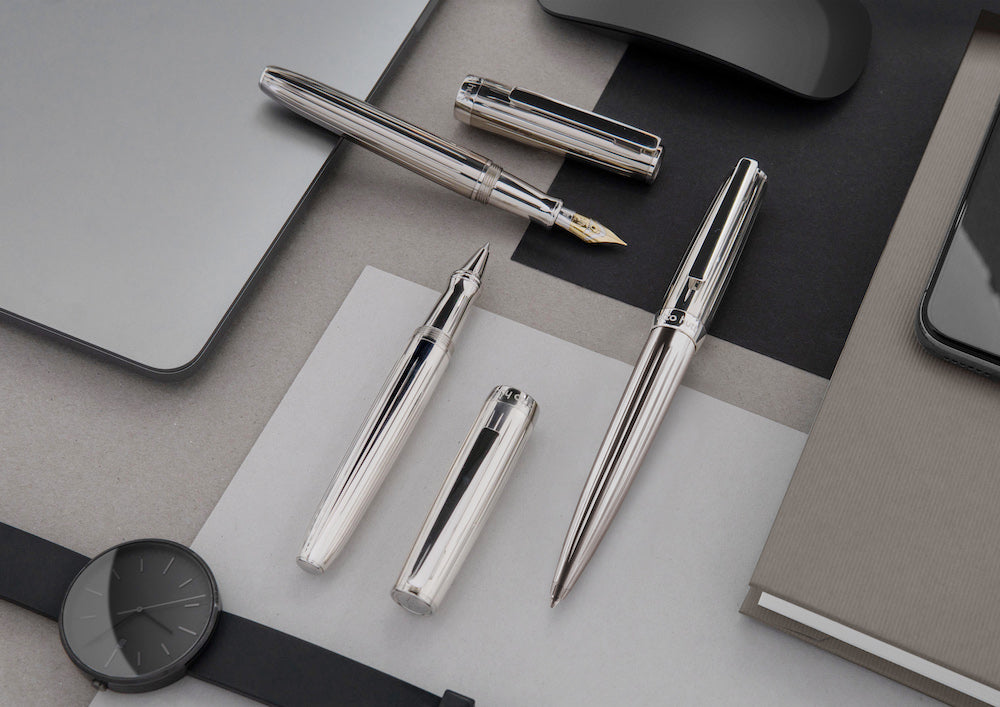 Otto Hutt Design 7 Fountain Pen - Sterling Silver Made in Germany lifestyle
Set of silver pens and a watch on a gray surface
