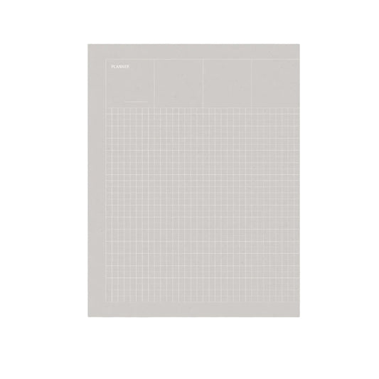 A minimalist gray planner pad with a fine grid pattern and a small 'PLANNER' label in the top left, shown standing upright on a light gray background. Grid Undated Planner - Fountain Pen Friendly Planner - Warm Grey