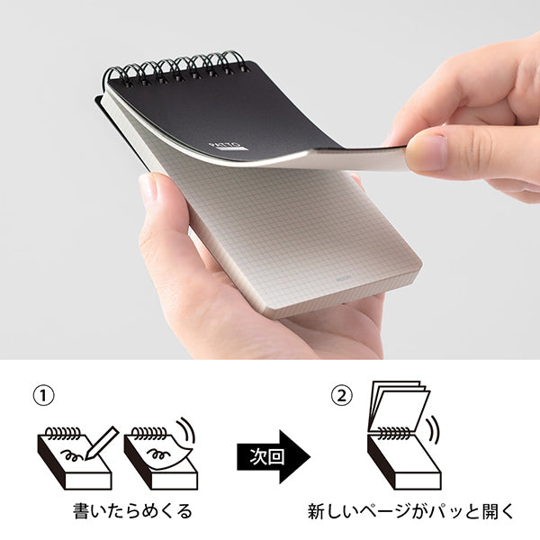 Notebook with a pen holder being held, showing the mechanism of page flipping. Midori Patto Quick Open Memo Pad - Black - Made in Japan