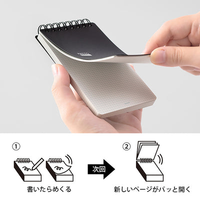 Notebook with a pen holder being held, showing the mechanism of page flipping. Midori Patto Quick Open Memo Pad - Black - Made in Japan