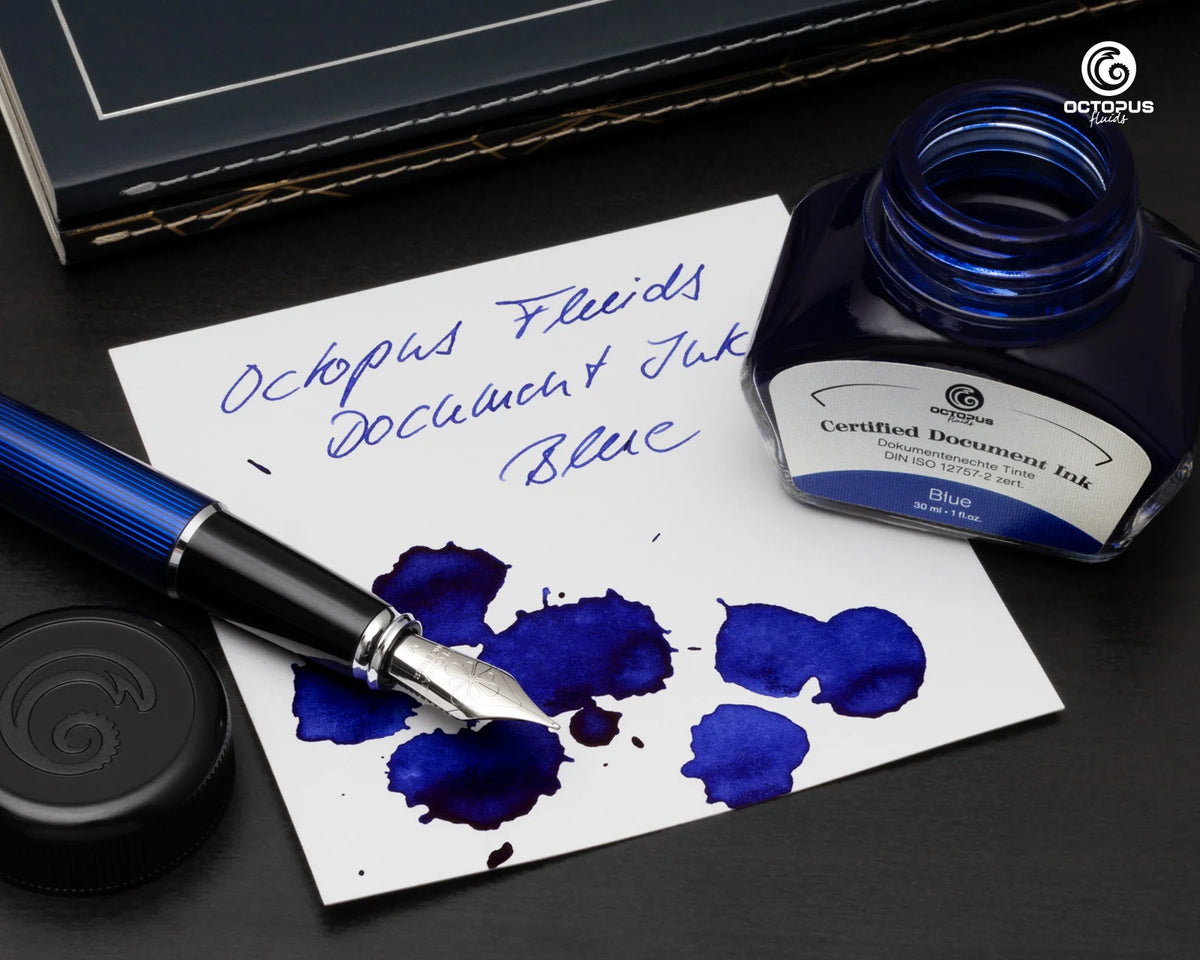 Fountain pen with blue ink on paper and Octopus Ink bottle on a dark surface Octopus Fluids Fountain Pen Document Ink - 30 ml Bottle - Dark Blue -  Made in Germany