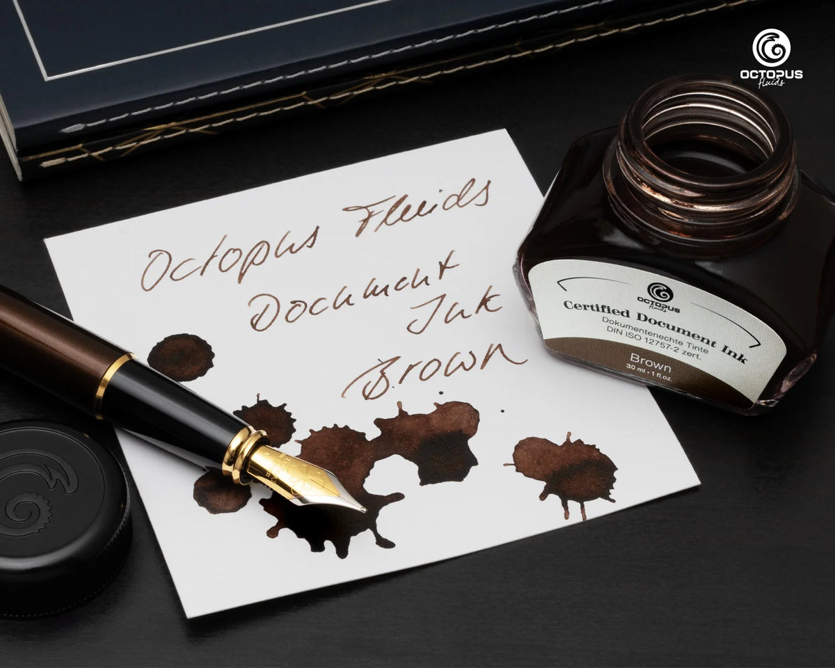 Ink bottle and fountain pen with brown ink on a white paper, branded 'Octopus'. Octopus Fluids Fountain Pen Document Ink - 30 ml Bottle - Brown -  Made in Germany