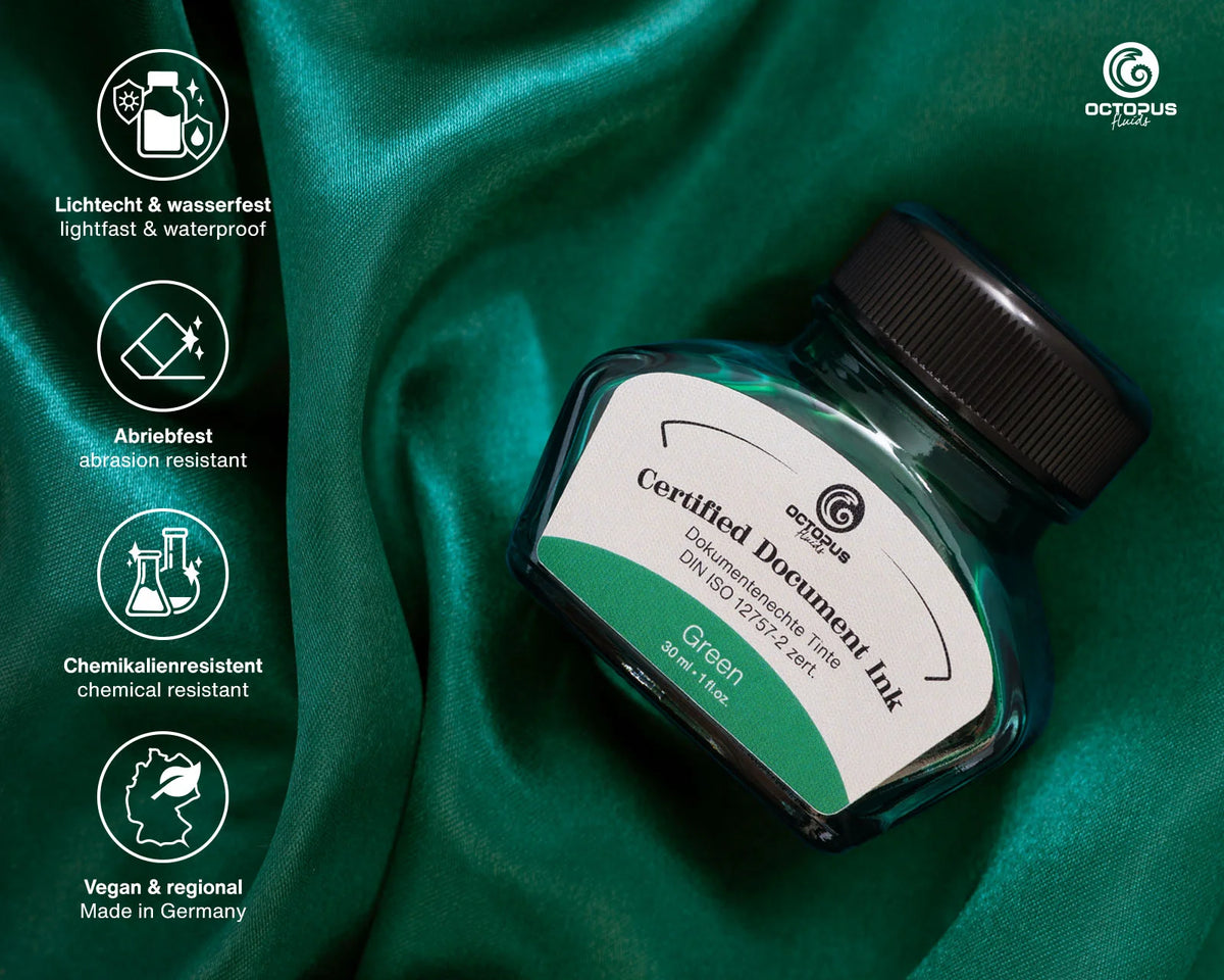 Green ink bottle with certification icons on a green fabric background