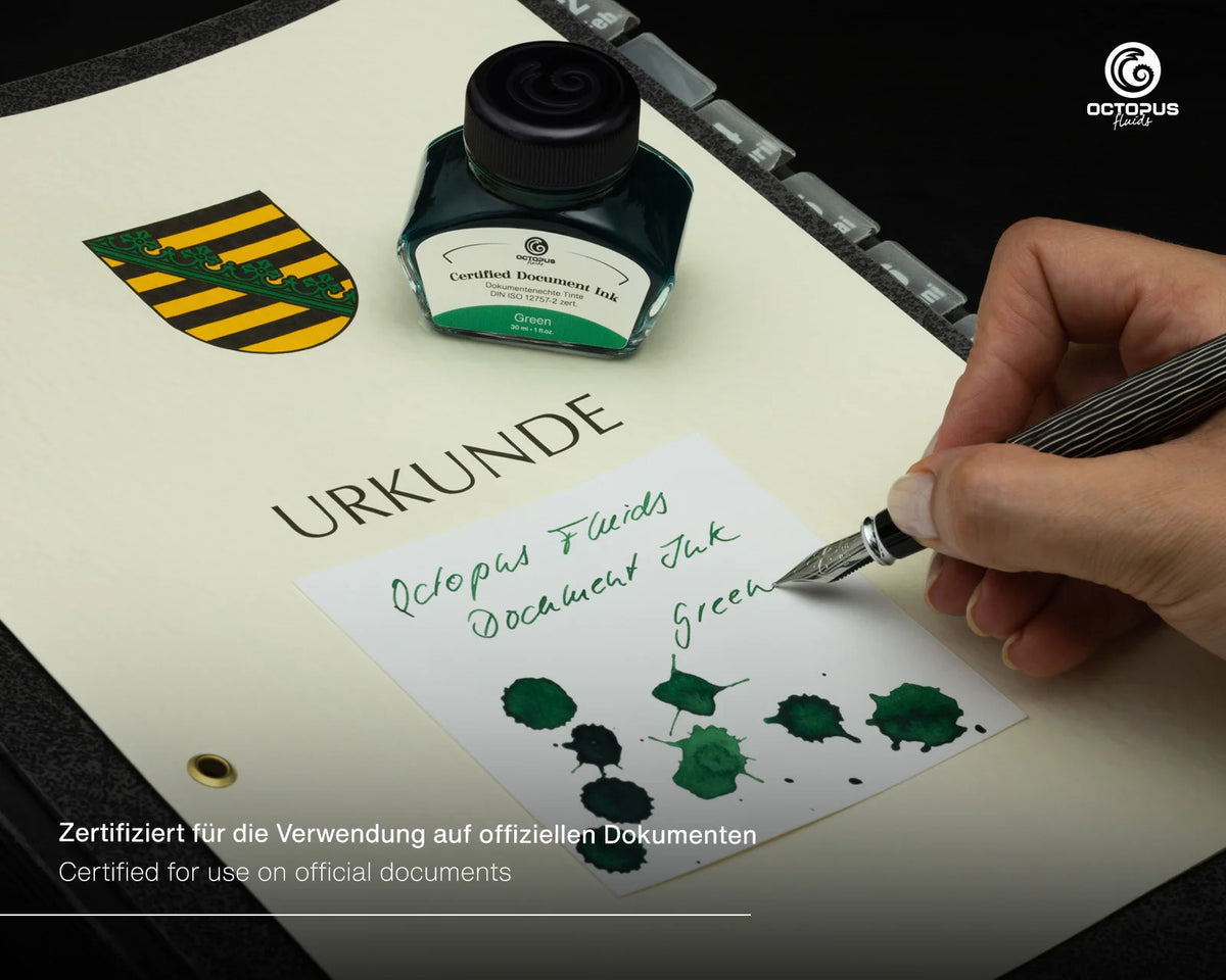 Octopus Fluids Document green ink bottle and a hand writing with a silver pen on a document, with a black and yellow crest and certification text visible.