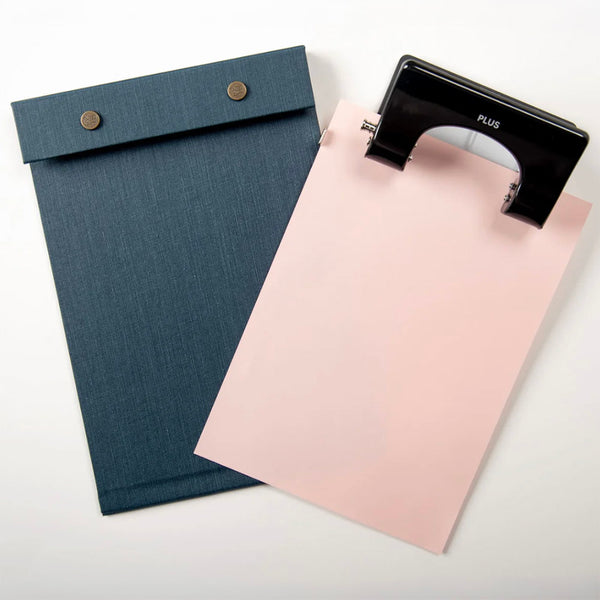 Postalco Snap Pad PLUS 2 hole punch black in action with snap pad