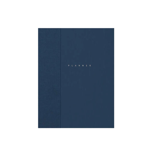 A navy blue hardcover planner standing upright against a light gray background. The word 'PLANNER' is printed in small gold letters near the center. Papierniczeni Klasyk Undated Planner Fountain Pen Friendly midnight